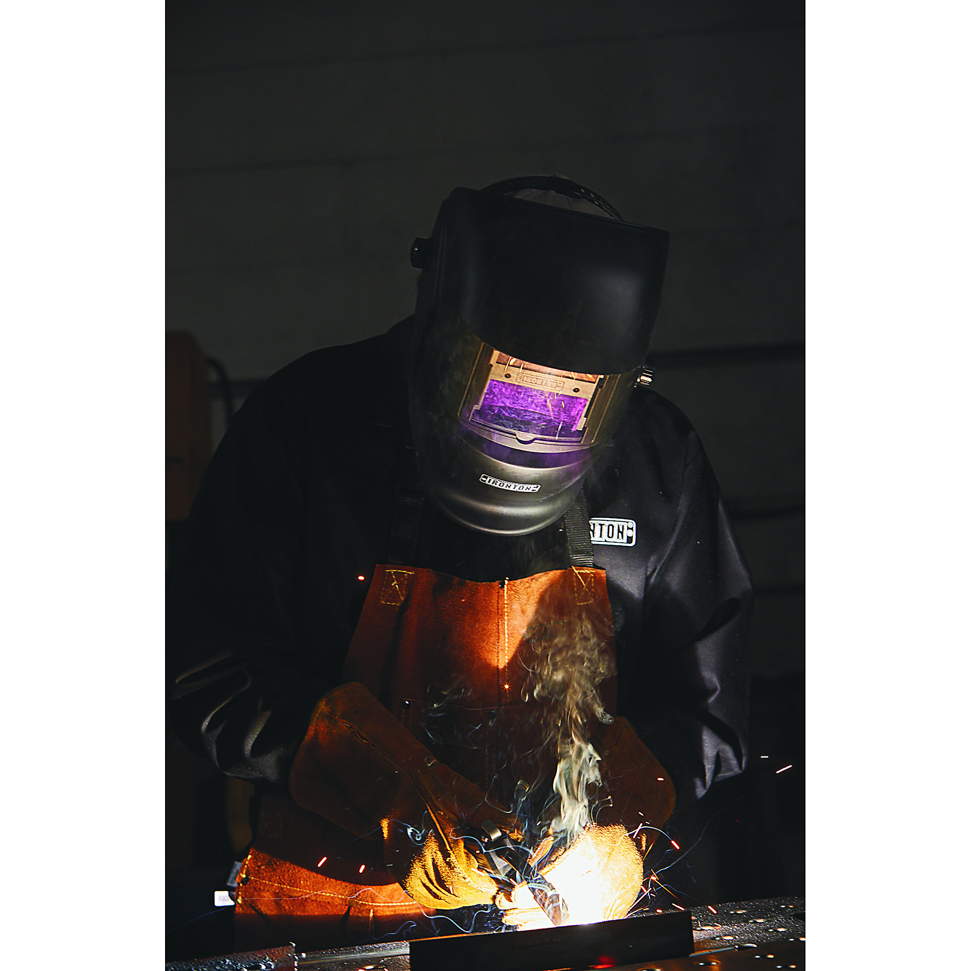 Man Welding with an Ironton Welding Helmet
